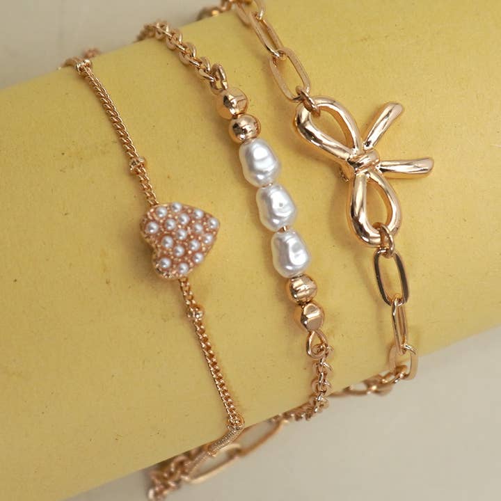 JOSSLYN by Wall to Wall Charm Bracelet-Multi Layer Bow Pearl Heart Charms