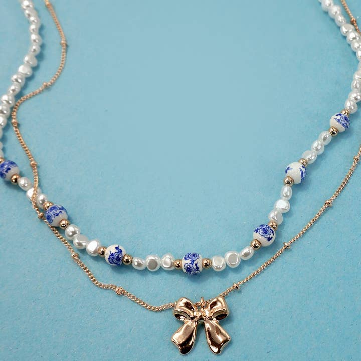 JOSSLYN by Wall to Wall Ceramic Porcelain Pearl Bow Layer Necklace