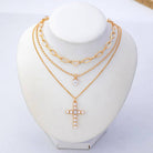 JOSSLYN by Wall to Wall Multi-Layered Pearl Cross Rhinestone Necklace | 80N93577 by JOSSLYN by Wall to Wall